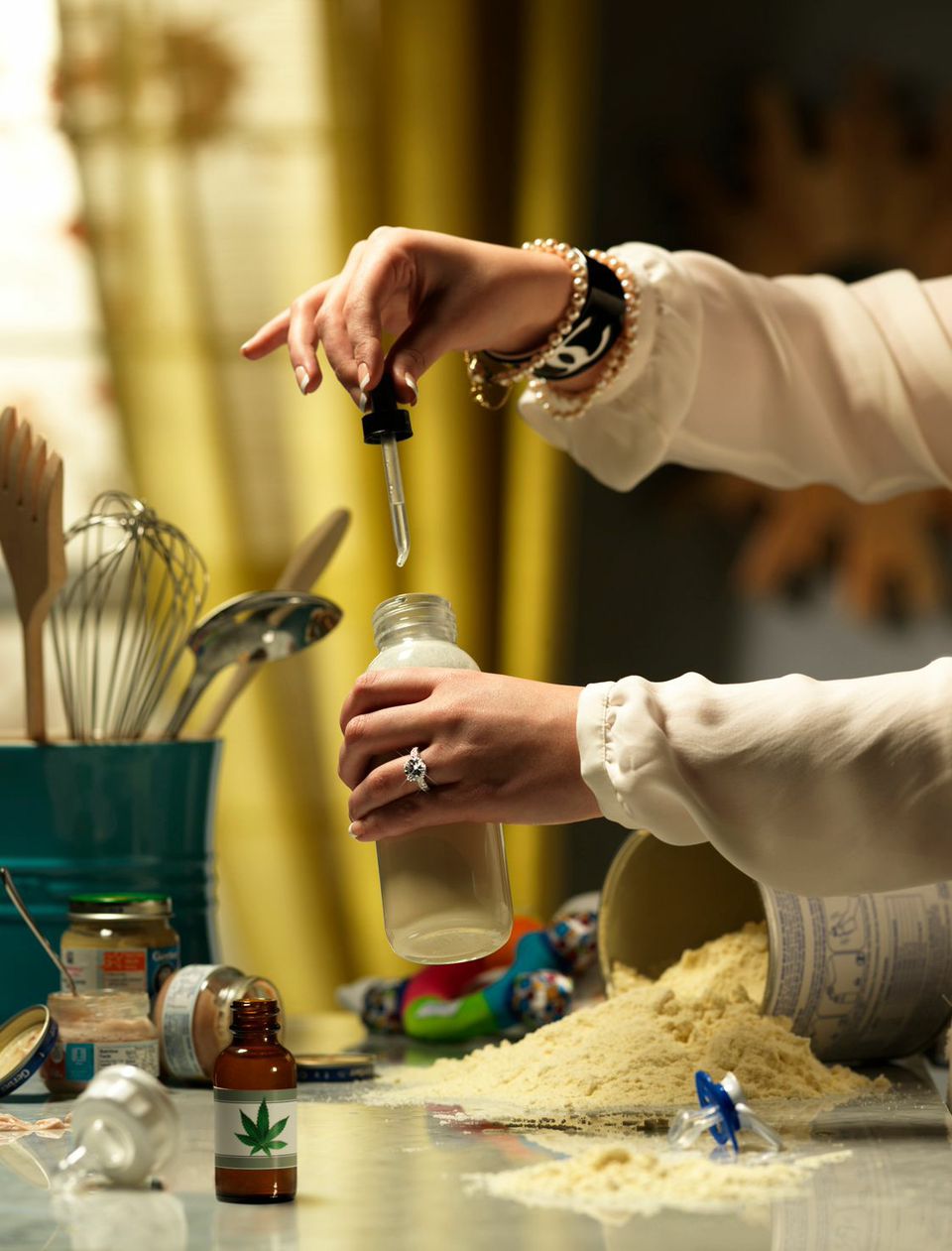 Photo of a Womans Hands with Weed Drops and Baby Bottle  — Studio 3, Inc.