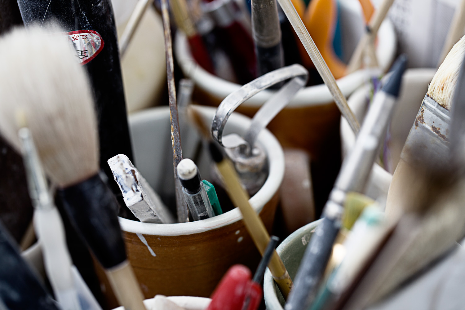 Close up lifestyle photography of artist pottery tools at ceramics studio  — Studio 3, Inc.