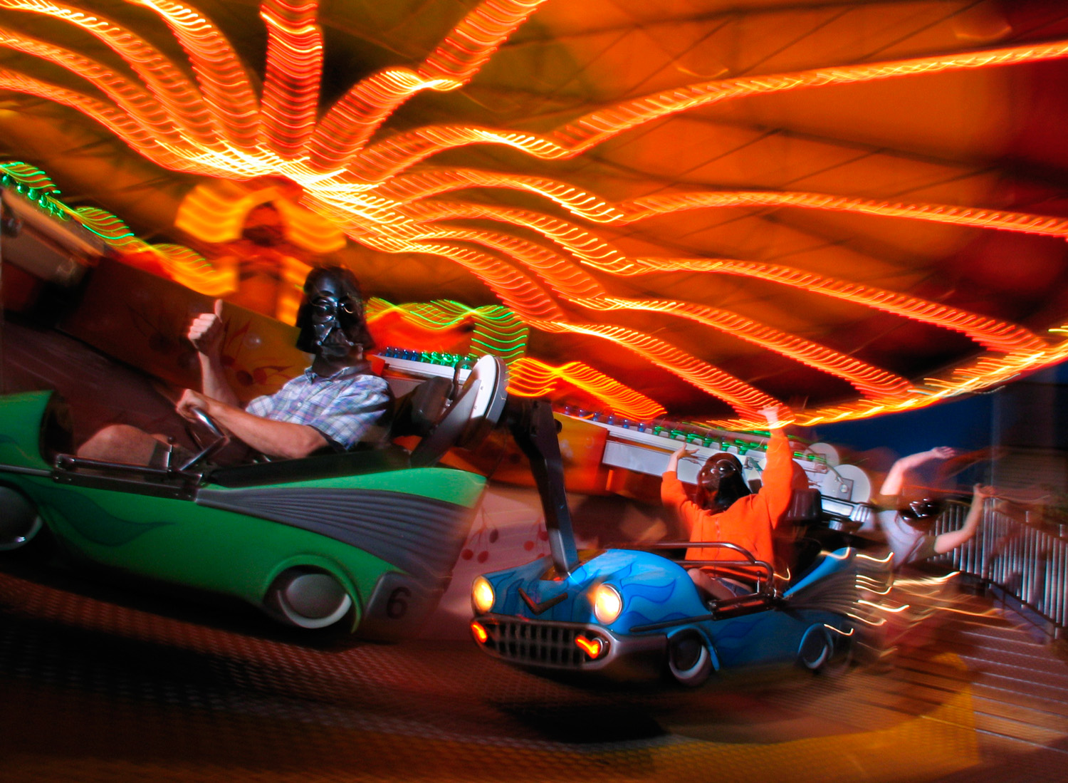 People in Darth Vader masks riding carousel ride at amusement park on location having fun  — Studio 3, Inc.