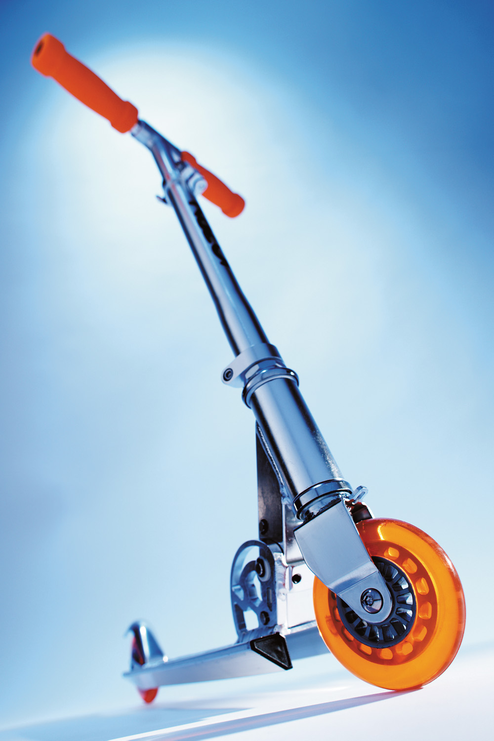 orange razer scooter blue background  — Studio 3, Inc.