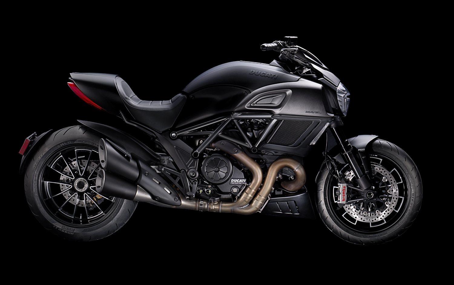 Black Ducati motorcycle from side on black background  — Studio 3, Inc.