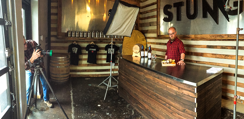 Photographer Craig Wagner shooting drink photography of Stung Fermented on tabletop  — Studio 3, Inc.