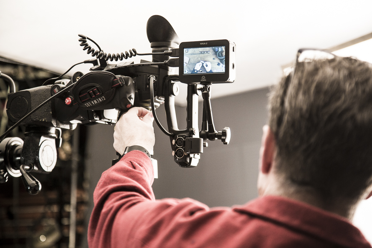Director David King adjusting the video camera on set of the Leatherman Wingman video shoot  — Studio 3, Inc.