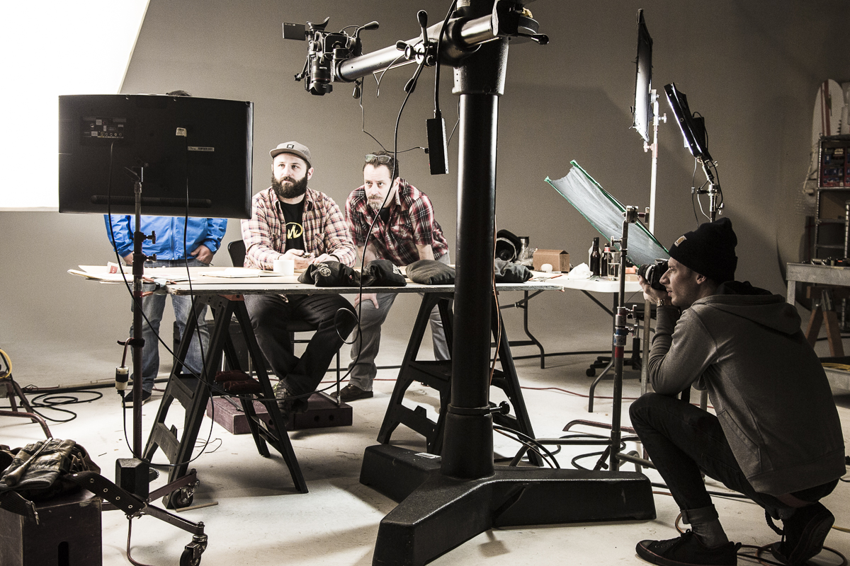 Assistant Trevor Boone taking a production still shot of Director David King and talent on set of the Leatherman Wingman video shoot  — Studio 3, Inc.