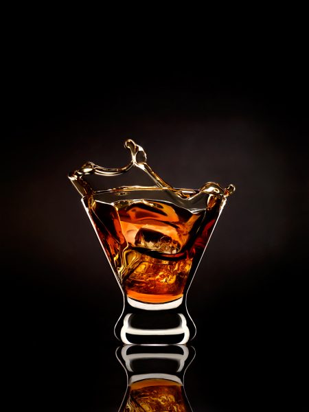Glass of Whiskey with Ice Dropped In  — Studio 3, Inc.