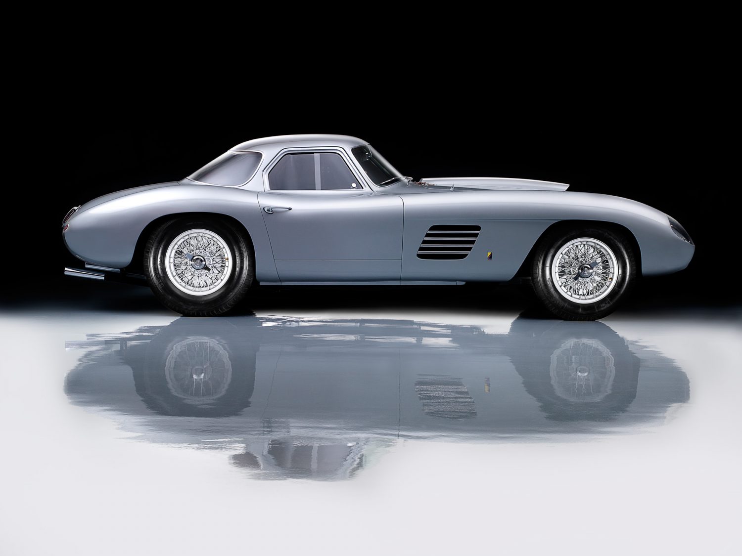 Gray 1954 Ferrari 375 MM Scagliette Coupe on reflective surface for Griot's Garage