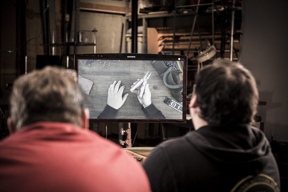 Director David King and talent watch the video monitor on set of the Leatherman Wingman video shoot
